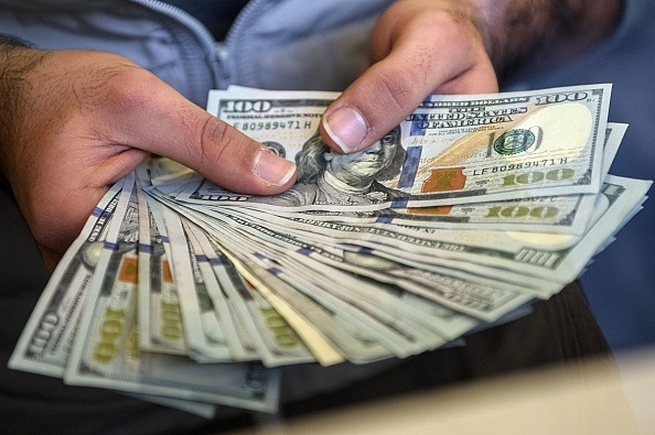 

A change office staff shows US dollars. (OZAN KOSE/AFP/GettyImages)