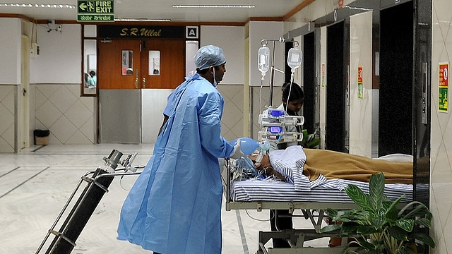 Hospital staff shift a patient at the Narayana Hrudayalaya cardiac-care hospital in Bengaluru. (Manjunath Kiran/AFP/Getty Images)