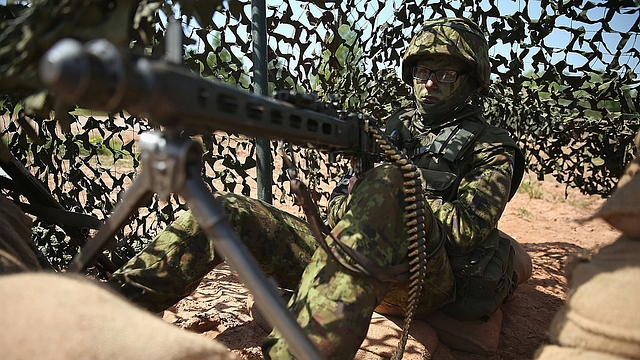 An Estonian soldier mans a machine gun prior to an aircraft attack demonstration during the NATO ‘Spring Storm’ military exercises. (Sean Gallup/Getty Images)