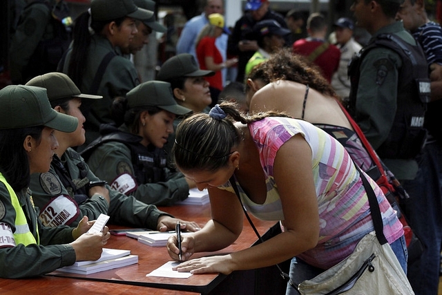 

A Venezuelan woman at customs, before crossing over the Simon Bolivar international bridge into Colombia. <a href="http://pictures.reuters.com/Doc/RTR/Media/TR3/2/d/0/e/RTX2KKON.jpg">Eduardo Ramirez/Reuters</a>