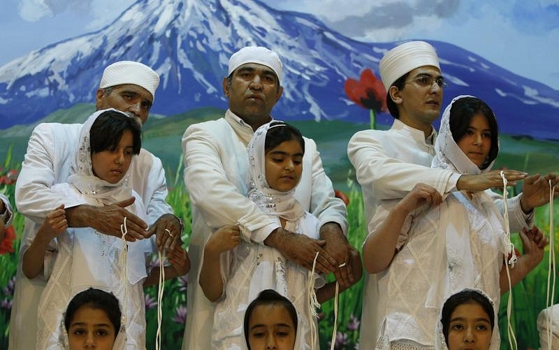 Zoroastrian priests performing a group Navjote initiation ceremony.