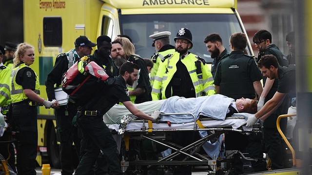 A member of the public is treated by emergency services near Westminster Bridge and the Houses of Parliament after the terror attack. (Carl Court/GettyImages) &nbsp;