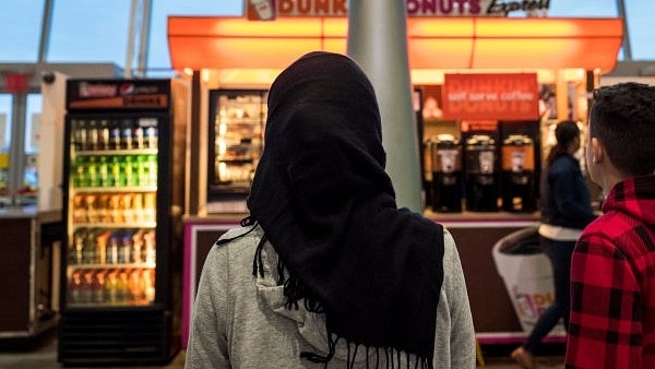 A young woman wearing a Hijab watches on. (Drew Angerer/Getty Images)&nbsp;