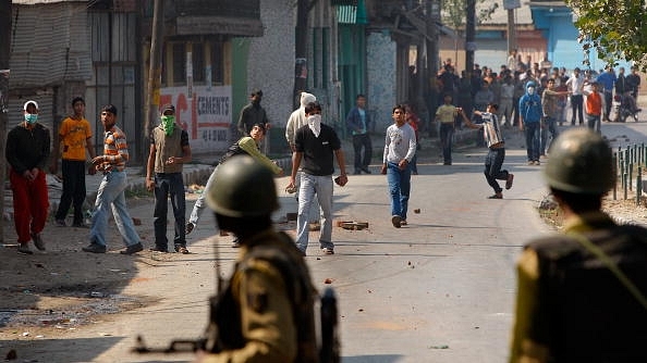 Kashmiri youth throw stones at the Indian military  in Srinagar. (Paula Bronstein/GettyImages)