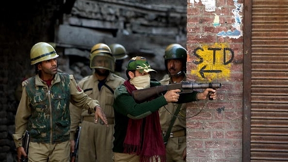 Indian paramilitary forces watch and act against rock-throwing youths in Srinagar, Kashmir.