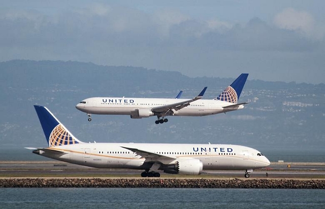 
A United Airlines Boeing 787 taxis as a United Airlines Boeing 767 lands.

