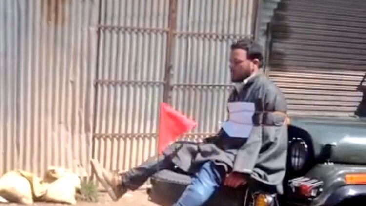 A stone pelter in the Kashmir valley tied to a vehicle. 