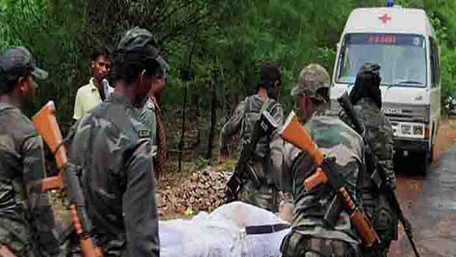 CRPF personnel carry an injured soldier.