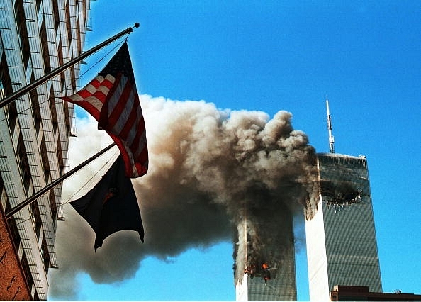 Smoke pouring from the World Trade Center after it was hit by two planes on 11 September 2001 in New York City. (Craig Allen/Getty Images)