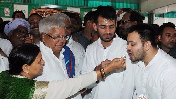 Former Bihar chief minister Rabri Devi  with husband Lalu Prasad and their two sons. (AP Dube/Hindustan Times via Getty Images)