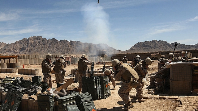  U.S. Marines fire a 120 mm white phosphorous mortar towards a Taliban position on April 3, 2009 in Now Zad in Helmand province, Afghanistan. (Photo by John Moore/Getty Images)