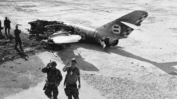 

Advancing Israeli troops pass the wreckage of an Arab warplane near El Arish Airport, during the Six-Day war. (Terry Fincher/Express/Getty Images)