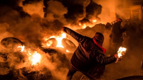 An anti-government protester throws a Molotov cocktail during clashes with police in Kiev, Ukraine. (Brendan Hoffman/Getty Images)