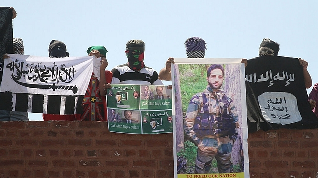 Masked Kashmiri youth hold ISIS, Lashkar-e-Taiba flags and posters of  Mohammad Ali Jinnah and former ISI Chief Hamid Gul and local commander Hizbul Mujahideen Burhan Wani during a protest outside Jamia Masjid in downtown Srinagar (Abid Bhat/Hindustan Times via Getty Images)&nbsp;