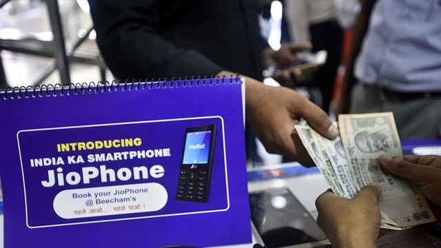 A customer at Reliance store for Jio phone pre-booking at Connaught Place in New Delhi. (Arun Sharma/Hindustan Times via GettyImages) &nbsp;