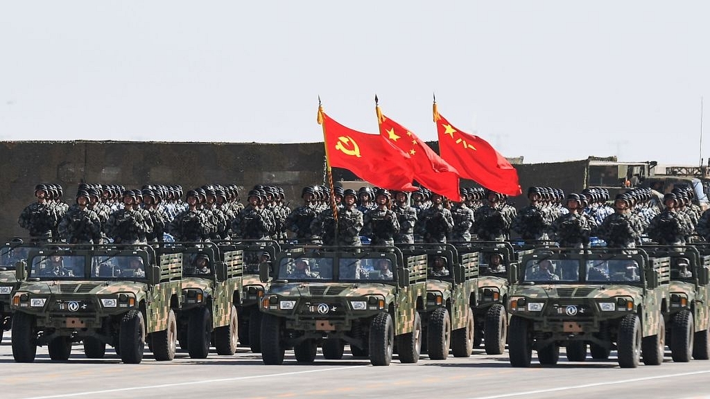 Chinese soldiers carry the flags of (L to R) the Communist Party, the state, and the People’s Liberation Army during a military parade at the Zhurihe training base in China’s northern Inner Mongolia region on July 30, 2017. (STR/AFP/Getty Images)