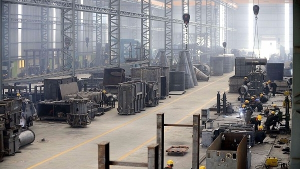 Indian workers at a heavy fabrication manufacturing factory in Vasna Buzarg village, near Ahmedabad in December 2016. (SAM PANTHAKY/AFP/Getty Images)