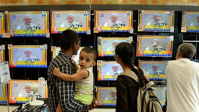 Prime Minister Narendra Modi’s oath-taking on TVs (INDRANIL MUKHERJEE/AFP/Getty Images)&nbsp;