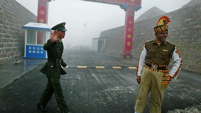 Indian and Chinese soldiers at a border crossing. (Diptendu Dutta/GettyImage)