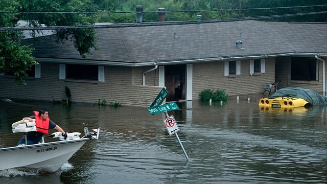 

A boat passes through a flooded street during the aftermath of Hurricane Harvey in Houston, Texas.  (BRENDAN SMIALOWSKI/AFP/Getty Images)