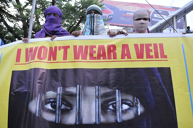 Women associated with India Against Love Jihad hold placards and form a human chain to protest against love jihad and conversion to Islam at MP Nagar on September 12, 2014 in Bhopal, India. (Mujeeb Faruqui/Hindustan Times via Getty Images)