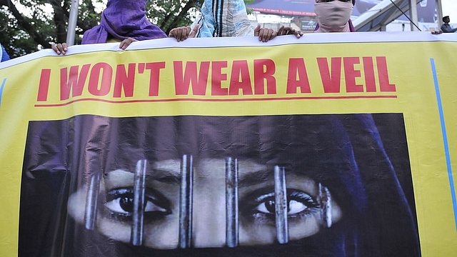 Women associated with India Against Love Jihad hold placards and form a human chain to protest against love jihad and conversion to Islam at MP Nagar on September 12, 2014 in Bhopal, India. (Mujeeb Faruqui/Hindustan Times via Getty Images)