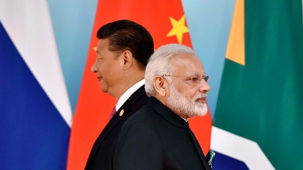 Chinese President Xi Jinping (L) and Prime Minister Narendra Modi at the group photo session during the BRICS Summit in China. (KENZABURO FUKUHARA/AFP/Getty Images)