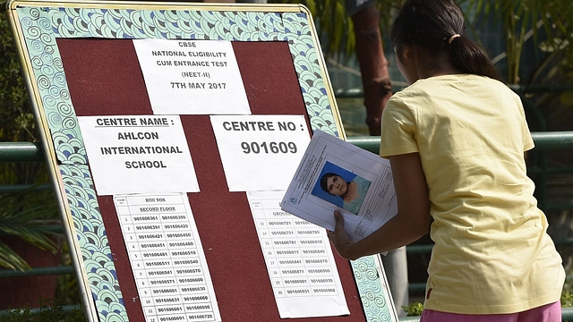 A candidate checks her seating arrangement for NEET. (Raj K Raj/Hindustan Times via Getty Images)