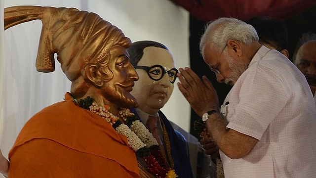 Prime Minister Narendra Modi pays his respects to Chattrapati Shivaji and the architect of India’s Constitution B R Abedkar before addressing an election rally in Mumbai. (INDRANIL MUKHERJEE/AFP/GettyImages)