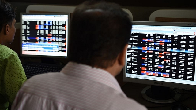 Indian stock traders watch share prices on their terminals. (INDRANIL MUKHERJEE/AFP/Getty Images)