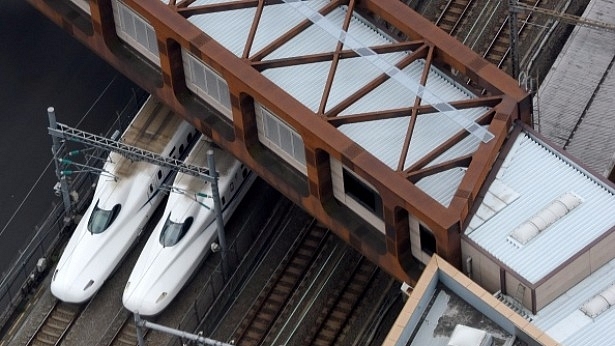 A pair of Shinkansen trains are seen under a pedestrian overbridge in Tokyo. (TORU YAMANAKA/AFP/Getty Images)