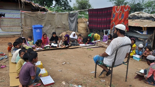  Rohingya Muslim refugee children from Myanmar study at a makeshift madrasa (religious school) on World Refugee Day in the outskirts of the Indian city Jammu on June 20, 2017. Hundreds of thousands of Muslim Rohingya have fled from Myanmar in recent decades, escaping persecution from the Buddhist-majority nation for generations. (AFP/Getty Images)