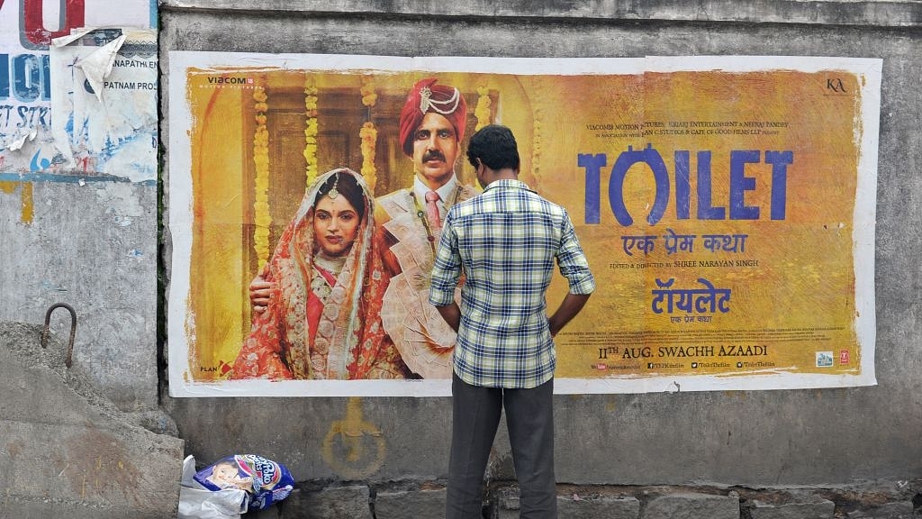 An Indian man urinates on a wall on the roadside in front of a poster for the Hindi film ‘Toilet’ in Hyderabad on August 12, 2017. The Bollywood film ‘Toilet: Ek Prem Katha’ (‘Toilet: A love story’), which was released on August 11, is inspired by the true-life tale of one man’s battle to build toilets in his village in rural India. / AFP PHOTO / NOAH SEELAM (Photo credit should read NOAH SEELAM/AFP/Getty Images)