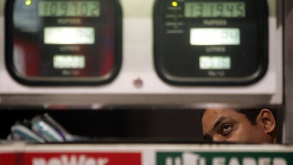 A car owner takes a close look at the metre at a petrol pump. (Manoj Patil/Hindustan Times via Getty Images)