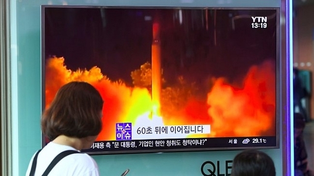 People watch a TV screen showing a video footage of North Korea’s latest test launch of an intercontinental ballistic missile (ICBM). (JUNG YEON-JE/AFP/Getty Images)