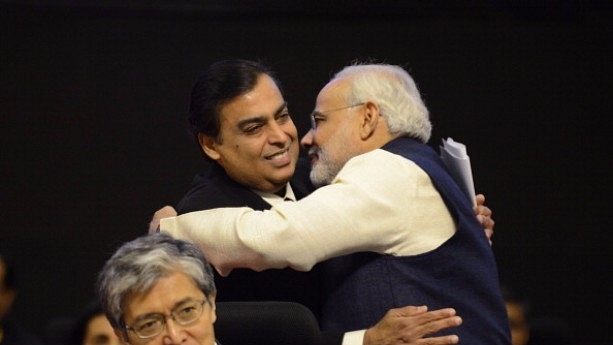 Narendra Modi (R) greets Reliance chairman and managing director Mukesh Ambani. (SAM PANTHAKY/AFP/Getty Images)