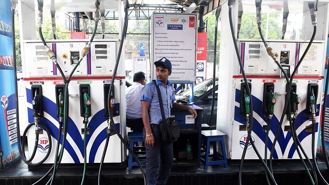 A petrol pump attendant waits for customers at a gas station in Kolkata. (DIBYANGSHU SARKAR/AFP/Getty Images)