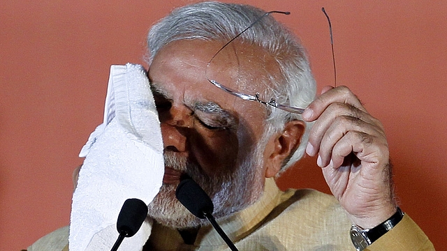 Narendra Modi wipes the sweat from his face during an election rally at MMRDA ground, BKC on April 21, 2014 in Mumbai, India. (Kunal Patil/Hindustan Times via Getty Images)