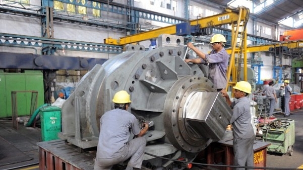 Labourers work on heavy machinery at the Elecon Engineering Company Limited factory in Vallabh Vidyanagar, near Ahmedabad. (SAM PANTHAKY/AFP/GettyImages)