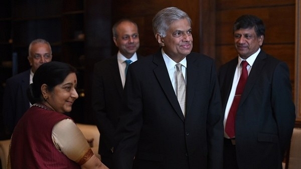 Sri Lanka’s Prime Minister Ranil Wickremesinghe shakes hands with Foreign Minister Sushma Swaraj (L) during the opening of the two-day Indian Ocean Conference 2017 in Colombo. (ISHARA S. KODIKARA/AFP/Getty Images)