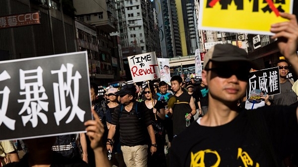 Activists hold banners and placards as they take part in an annual protest march on China’s national day in Hong Kong. (ISAAC LAWRENCE/AFP/Getty Images)