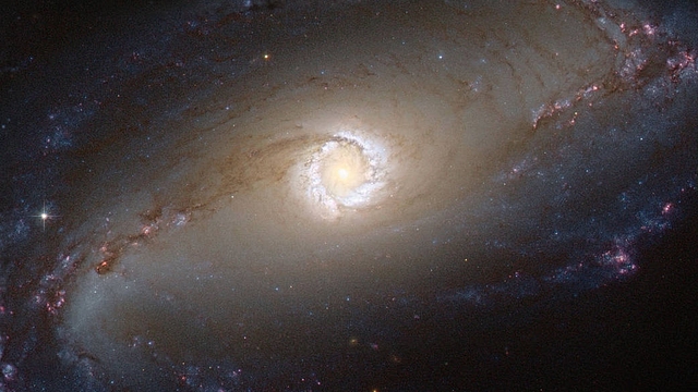 The Hubble Space Telescope captured a spectacular image of the bright star-forming ring that surrounds the heart of the barred spiral galaxy NGC 1097. (NASA/ESA/Hubble)