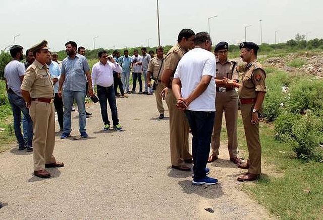 

                  Policemen stand 
near ATS roundabout, Greater Noida, where a gun battle took place 
between two criminal gangs and the police. (Shrikumar Bajpai/Hindustan 
Times)
                

