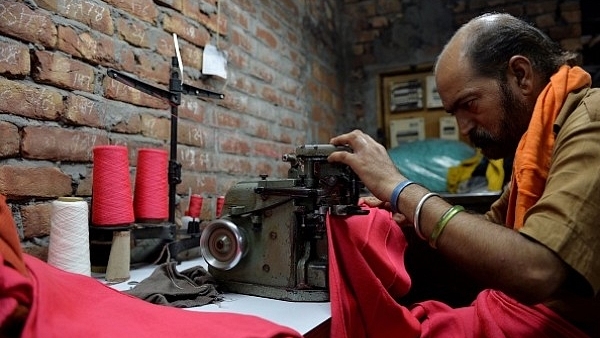 An Indian man works on a machine at a garment factory in Ludhiana. (MONEY SHARMA/AFP/Getty Images)