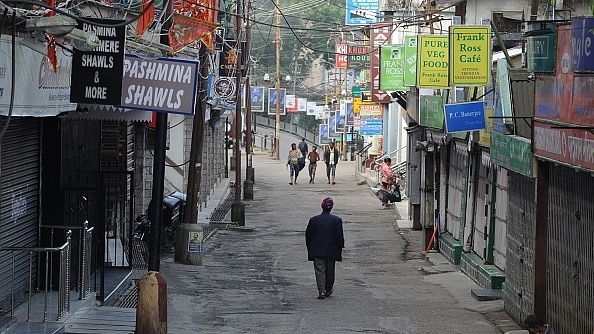 Residents walk in the deserted market area during a general strike called by the GJM in Darjeeling. (DIPTENDU DUTTA/AFP/GettyImages)