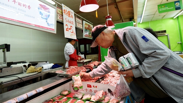 Customers select pork at a supermarket in Hangzhou, east China’s Zhejiang province on April 12, 2017. (STR/AFP/Getty Images)