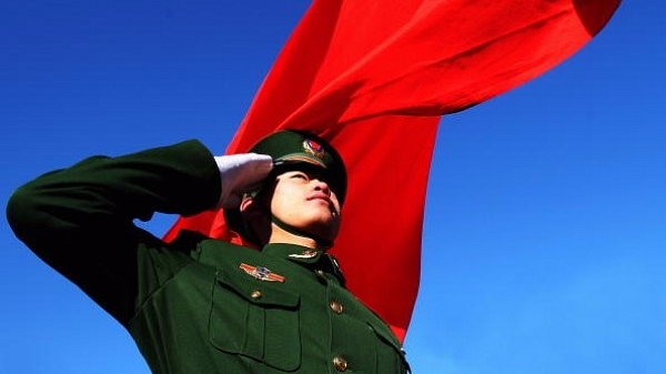  Paramilitary policeman does a national flag rising ceremony to mark the New Year before thousands of people climb the Great Wall on January 1, 2009 in Beijing, China. (Guang Niu/Getty Images)