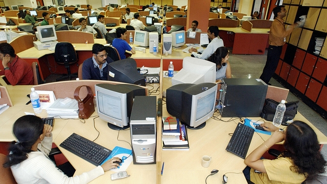 Software Professionals of Indian software firm Ivega Corp work at their workstations at the company’s office in Global Village in India’s technology hub on the outskirts of Bangalore 20 June 2003. (INDRANIL MUKHERJEE/AFP/Getty Images)