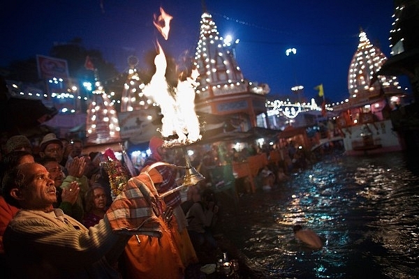 A Hindu priest performs the morning Ganga Arti Puja before sunrise on the banks of the Ganges river in Haridwar. (Daniel Berehulak/Getty Images)