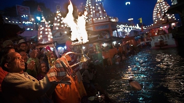 A Hindu priest performs the morning Ganga Arti Puja before sunrise on the banks of the Ganges river in Haridwar. (Daniel Berehulak/Getty Images)